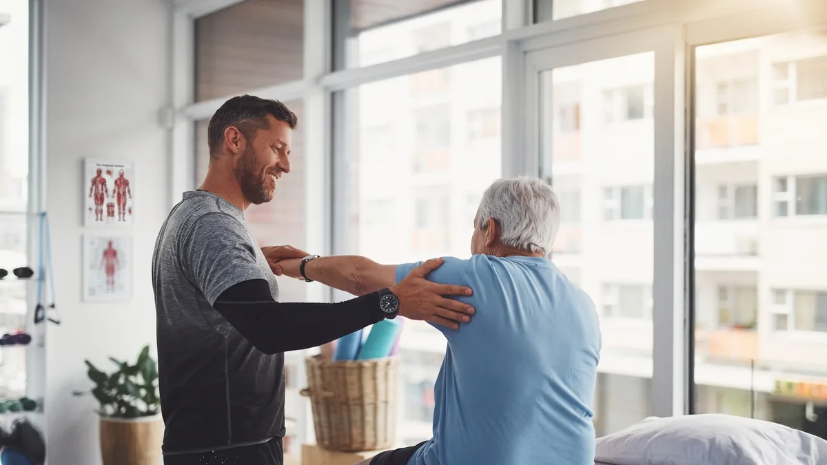 Physical therapist working with a patient in a clinic setting