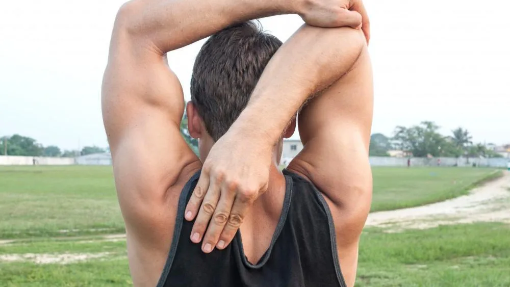 Baseball pitcher receiving shoulder care for throwing-related shoulder pain