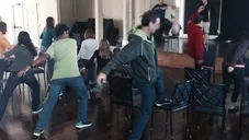 Group of people practicing running drills together indoors at a presentation
