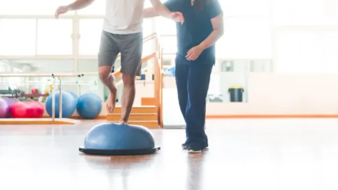 A patient practicing balance and gait exercises during vestibular rehabilitation