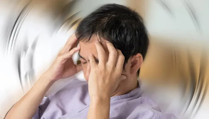 Physical therapist assessing a patient's balance and vestibular function