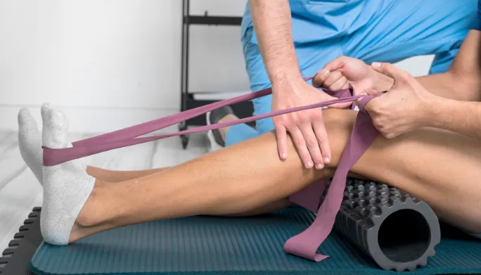 Physical therapist assessing a patient's foot and ankle mobility