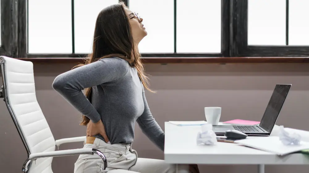 Physical therapist assessing a patient's low back movement and mobility