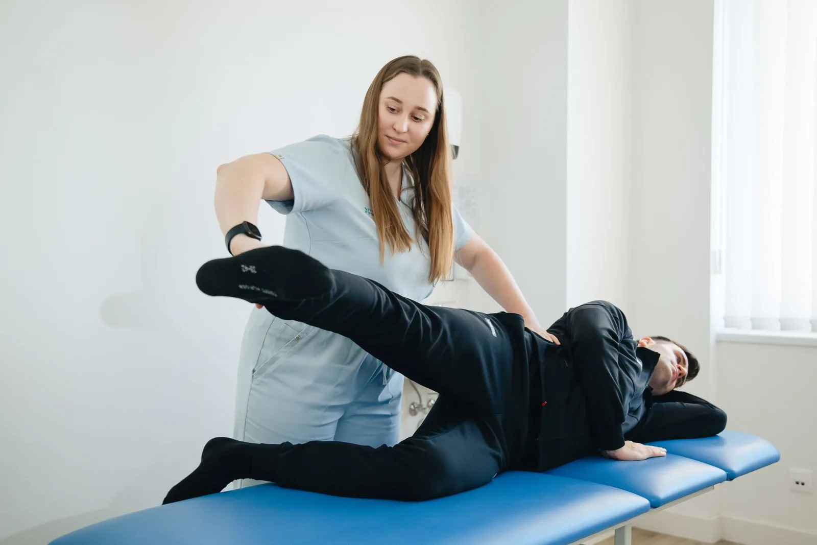 Patient working through guided mobility exercises with a therapist