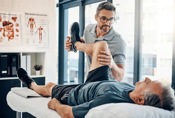 Physical therapist guiding a patient through a hands-on treatment session