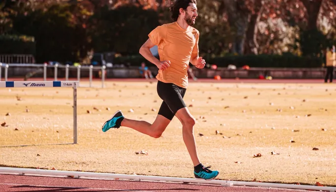 Runner in mid-stride on an outdoor track