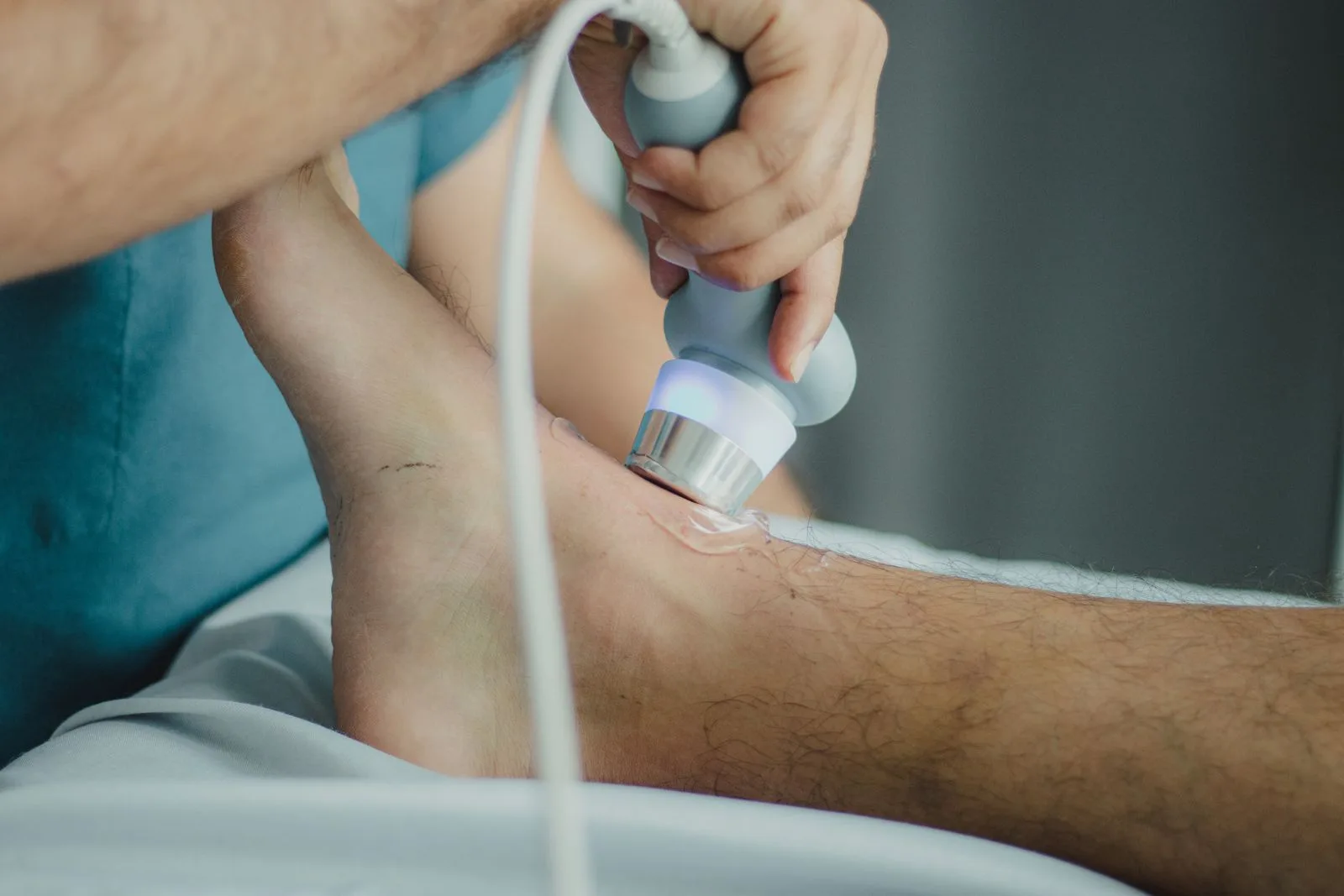 Therapy device being applied to a patient's Achilles tendon