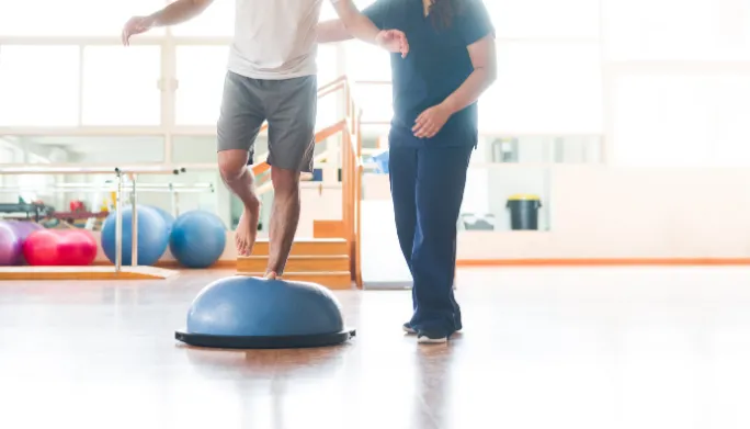 Physical therapist guiding a patient through vestibular balance exercises