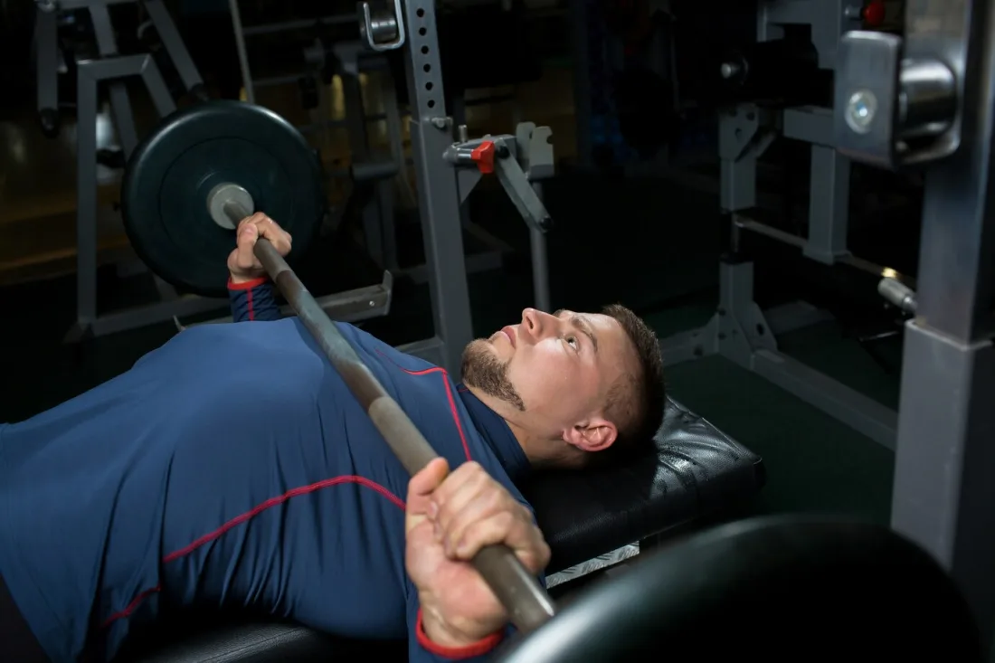 Physical therapist analyzing a client's weight lifting form on video